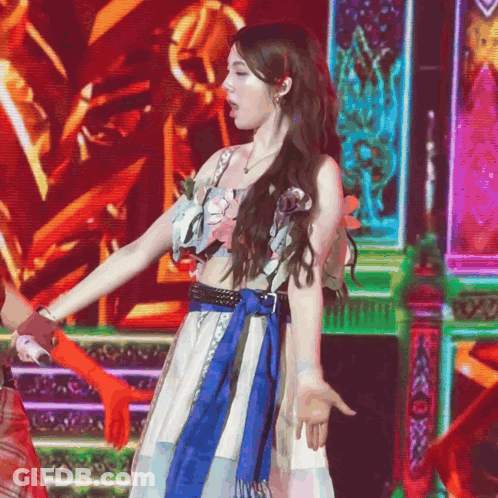 A Woman In A Blue And White Dress Is Dancing GIF