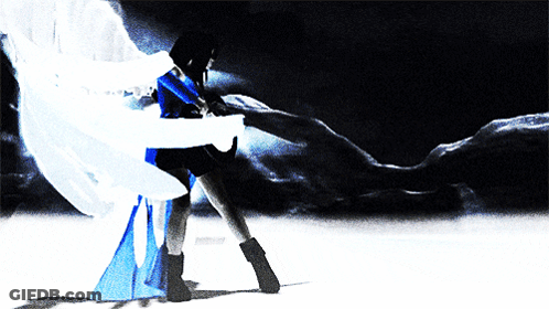 A Woman In A Blue And White Dress Is Dancing In The Dark GIF