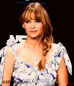 A Woman In A Blue And White Dress Is Making A Funny Face And Says `` Ok , Sure ! '' GIF
