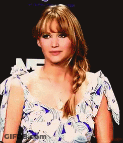 A Woman In A Blue And White Dress With A Braid On Her Hair GIF