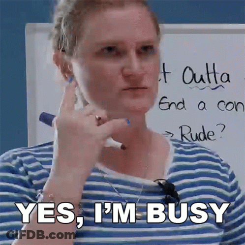 A Woman In A Blue And White Striped Shirt Says Yes I 'M Busy GIF