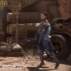 A Woman In A Blue Armor Stands In Front Of A Jeep GIF