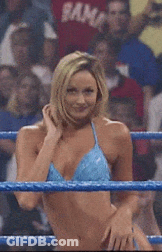 A Woman In A Blue Bikini Is Standing In A Ring With Her Hands On Her Hips GIF