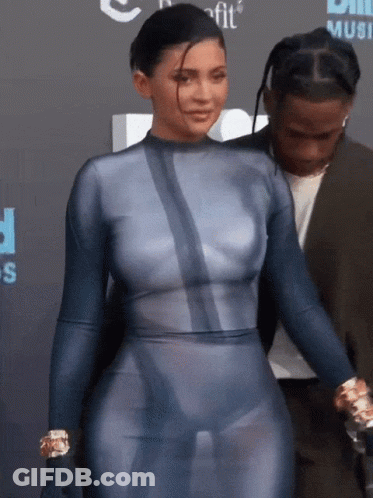 A Woman In A Blue Bodysuit Is Standing Next To A Man GIF