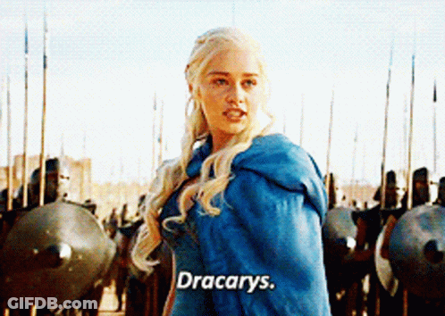 A Woman In A Blue Cape Is Standing In Front Of A Row Of Soldiers And Says " Dracarys " GIF