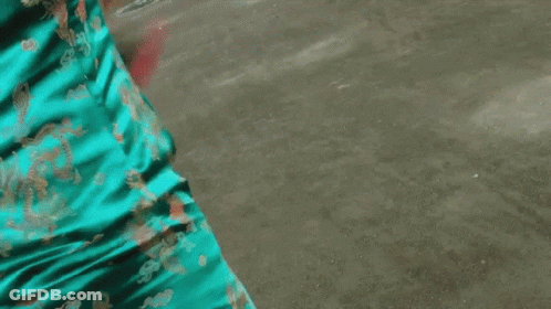 A Woman In A Blue Cheongsam Holds A Sword GIF