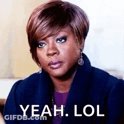 A Woman In A Blue Coat Is Making A Funny Face And Saying `` Yeah Lol '' . GIF