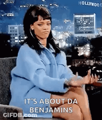 A Woman In A Blue Coat Is Sitting In A Chair With Her Hands Outstretched . GIF