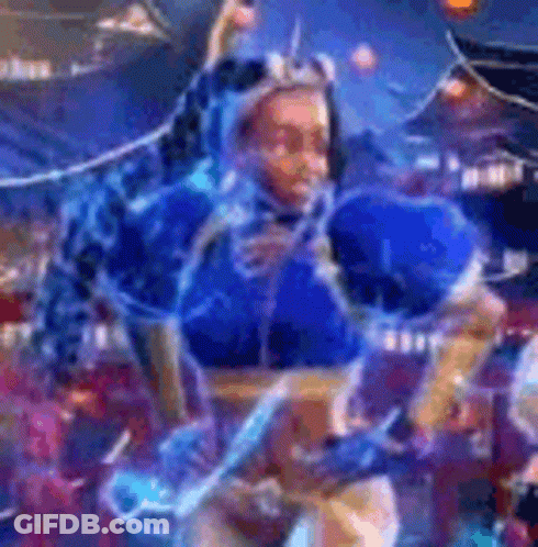 A Woman In A Blue Costume Is Dancing In Front Of A Crowd In A Video Game . GIF