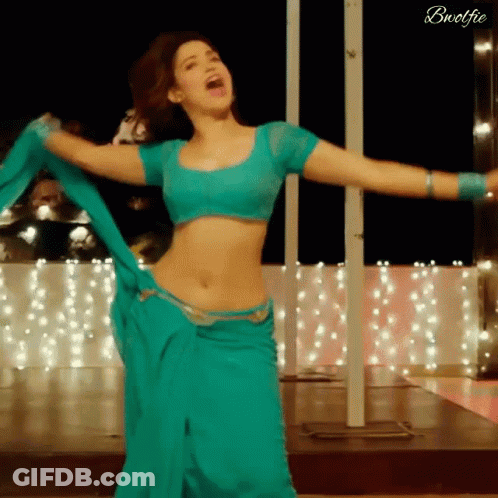 A Woman In A Blue Crop Top And A Blue Skirt Is Dancing GIF
