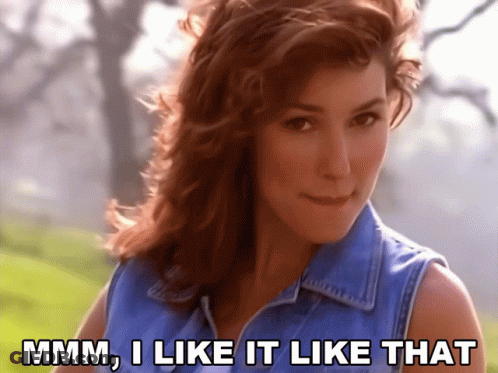 A Woman In A Blue Denim Vest Says " Mmm I Like It Like That " GIF