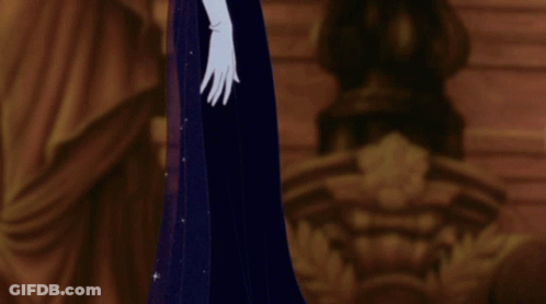 A Woman In A Blue Dress And White Gloves Stands In A Dark Room GIF