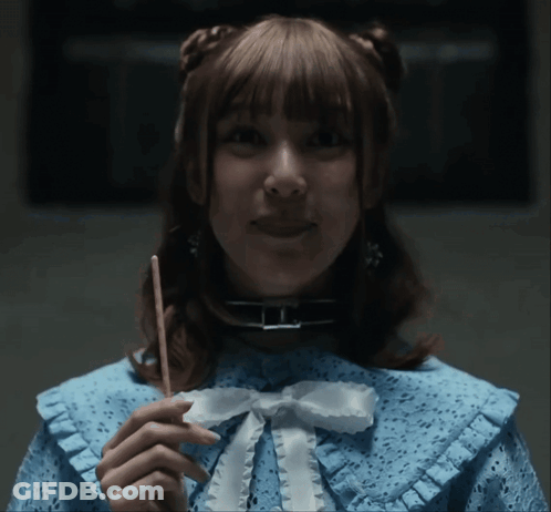 A Woman In A Blue Dress Holding A Stick GIF