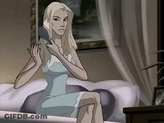 A Woman In A Blue Dress Is Brushing Her Hair While Sitting On A Bed . GIF