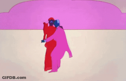 A Woman In A Blue Dress Is Dancing In Front Of A Pink Wall GIF