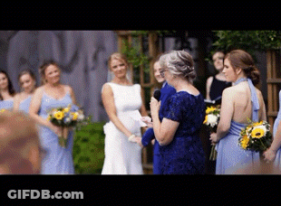 A Woman In A Blue Dress Is Giving A Speech At A Wedding GIF
