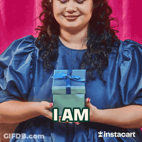 Woman In Blue Dress Holding Gift Box I Am GIF
