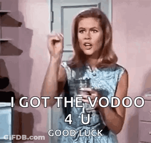 A Woman In A Blue Dress Is Holding A Glass Of Water And Saying `` I Got The Vodoo 4 U Good Luck '' . GIF