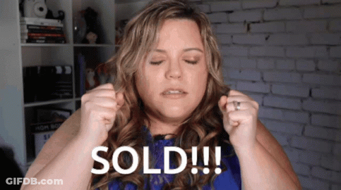 A Woman In A Blue Dress Is Holding Her Hair Up And Says Sold GIF