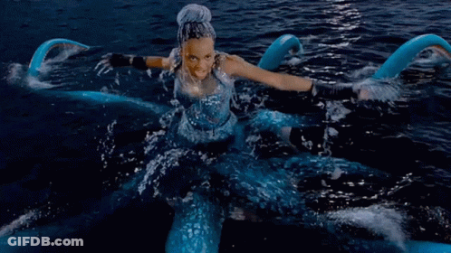 A Woman In A Blue Dress Is In The Water With The Words True Love 'S Kiss Won 'T Defeat This GIF