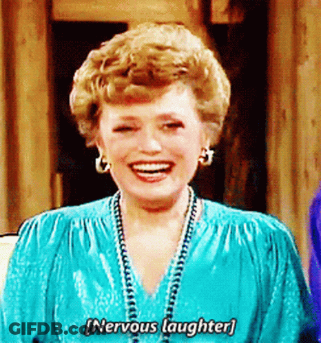 A Woman In A Blue Dress Is Laughing And Saying Nervous Laughter . GIF