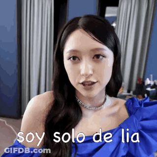 A Woman In A Blue Dress Is Making A Funny Face And Says `` Soy Solo De Lia '' . GIF