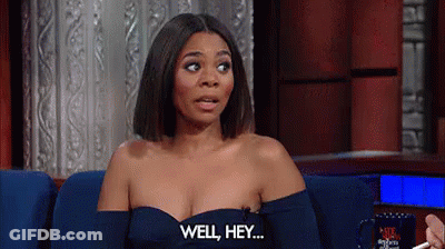 A Woman In A Blue Dress Is Sitting On A Couch And Saying `` Well , Hey . '' GIF
