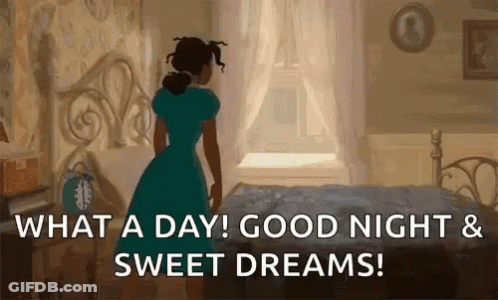 A Woman In A Blue Dress Is Standing In Front Of A Bed In A Bedroom And Looking Out The Window . GIF