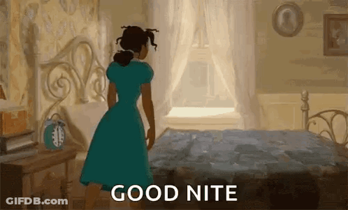 A Woman In A Blue Dress Is Standing In Front Of A Bed In A Bedroom And Saying `` Good Nite '' . GIF