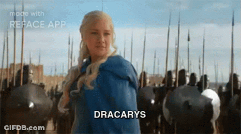 A Woman In A Blue Dress Is Standing In Front Of A Castle With A Sword In Her Hand . GIF