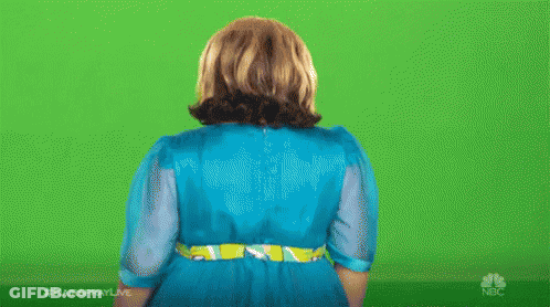 A Woman In A Blue Dress Is Standing In Front Of A Green Screen With Her Hands Outstretched . GIF