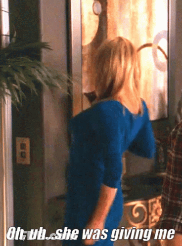 A Woman In A Blue Dress Is Standing In Front Of A Mirror And Says Oh Uh She Was Giving Me GIF