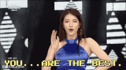 A Woman In A Blue Dress Is Standing In Front Of A Screen That Says You Are The Best GIF
