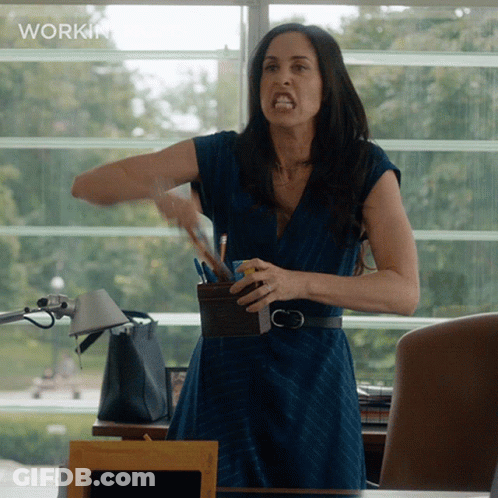 A Woman In A Blue Dress Is Standing In Front Of A Window With The Word Workin On The Bottom GIF