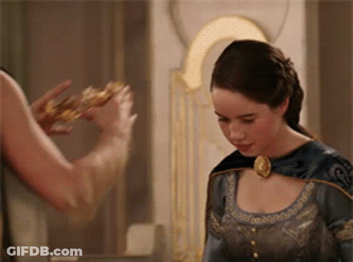 A Woman In A Blue Dress Is Standing Next To A Man Who Is Holding A Crown GIF