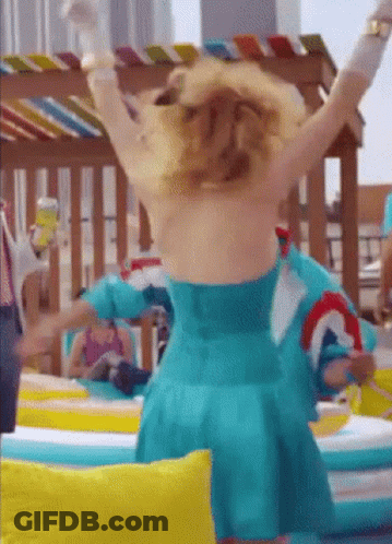 A Woman In A Blue Dress Is Standing With Her Arms Outstretched GIF