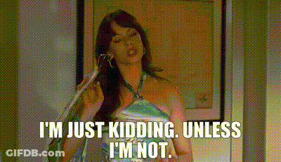A Woman In A Blue Dress Is Talking On A Cell Phone . GIF