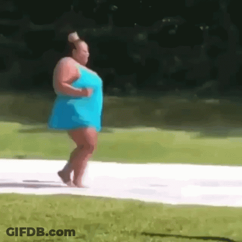 A Woman In A Blue Dress Is Walking Barefoot On A White Surface . GIF