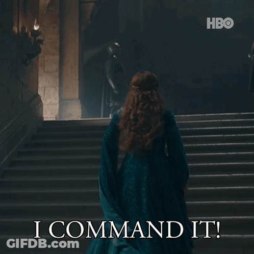 A Woman In A Blue Dress Is Walking Down A Set Of Stairs With The Words I Command It On The Bottom GIF