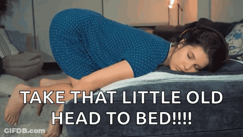 A Woman In A Blue Dress Laying On A Bed With The Words Take That Little Old Head To Bed GIF
