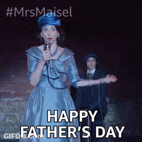 A Woman In A Blue Dress Singing Into A Microphone With The Words Happy Father 'S Day Below Her GIF