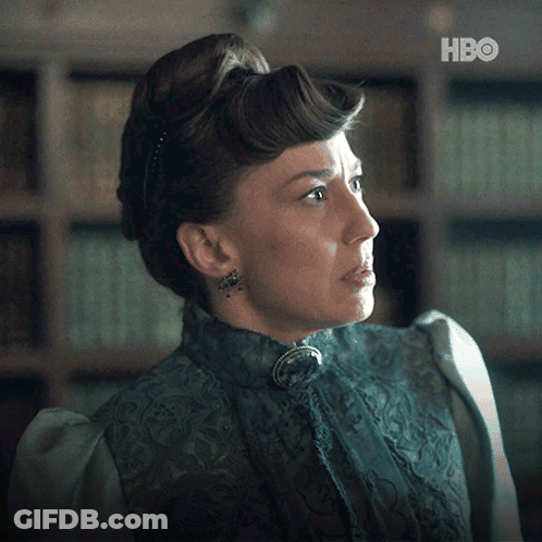 A Woman In A Blue Dress With A Hbo Logo On The Bottom GIF