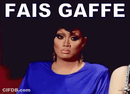 A Woman In A Blue Dress With The Words " Fais Gaffe " On Her Face GIF