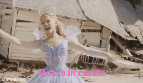 A Woman In A Blue Dress With The Words " Mocks In Cackle " On The Bottom Right GIF