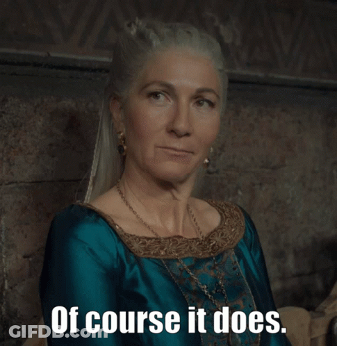 A Woman In A Blue Dress With The Words Of Course It Does Written Below Her GIF