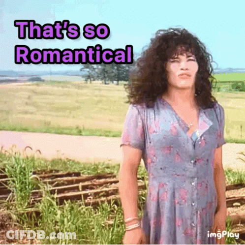 A Woman In A Blue Dress With The Words That 'S So Romantical GIF