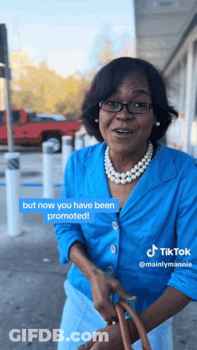 A Woman In A Blue Jacket And Pearls Says But Now You Have Been Promoted On A Tiktok GIF