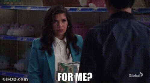 A Woman In A Blue Jacket Is Holding A Book And Asking For Me GIF