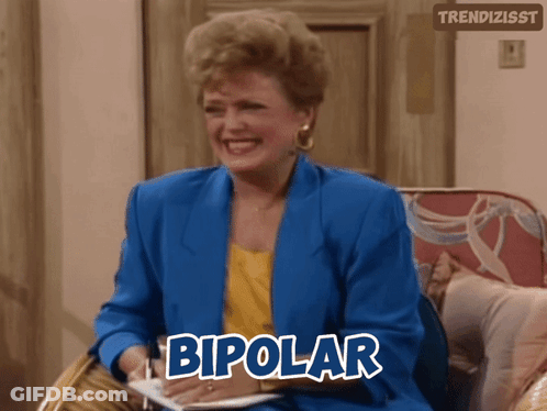 A Woman In A Blue Jacket Is Sitting In A Chair With The Word Bipolar Above Her GIF