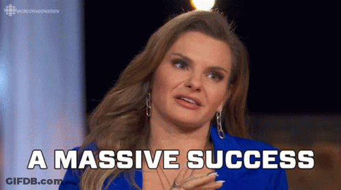 A Woman In A Blue Jacket Says " A Massive Success " In White Letters GIF